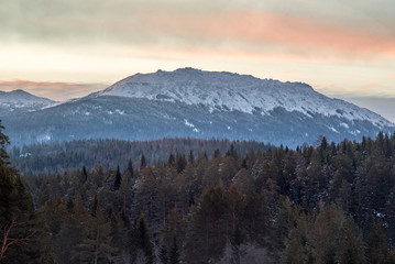 Fototapeta na wymiar Top of the mountain at sunrise. Ural mountain.Iremel. Majestic landscape glowing by sunlight in the morning. Dramatic and picturesque wintry scene.Beauty world. Happy New Year!