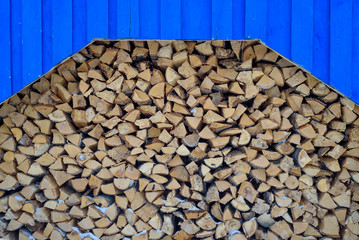 Stack of wood. Birch firewood. Old gray wooden background