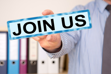 Businessman holding sign with inscription, JOIN US