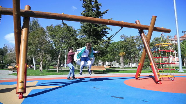 Two elementary aged children having fun in the playground