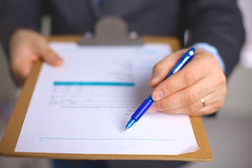 File folders, standing on shelves in the background