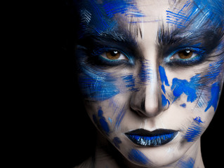 girl in blue paint on his face