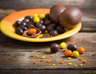 Chocolate Easter Eggs Over Wooden Table