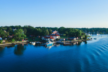 Obraz premium Beautiful super wide-angle panoramic aerial view of Stockholm archipelago, Sweden with harbor and skyline with scenery beyond the city, seen from the ferry, sunny summer day with blue sky
