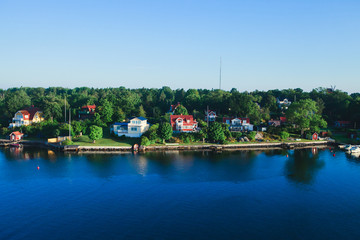 Fototapeta premium Beautiful super wide-angle panoramic aerial view of Stockholm archipelago, Sweden with harbor and skyline with scenery beyond the city, seen from the ferry, sunny summer day with blue sky