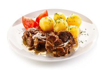 Roast steaks, boiled potatoes and vegetable salad 