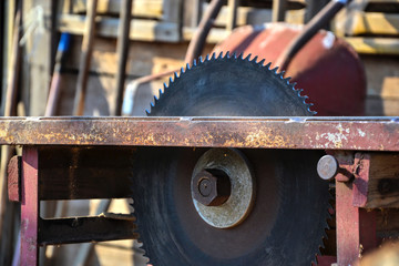 Close up of table circular saw blade in workshop. Woodwork, Work hazards. Dangerous serrated tablesaw