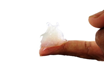 white petroleum jelly on finger in white background