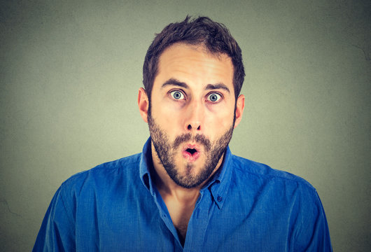 shocked man isolated on gray wall background