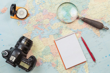 Planning and preparation of travel with map and glass magnifier