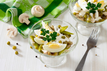 Salad with meat, mushrooms, pickles and green peas