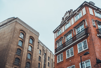 Fototapeta na wymiar Old Buildings in Industrial Area with Gray Sky