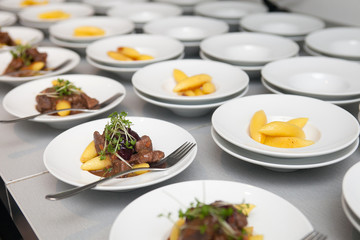 preparation of buffet plates with beef and Schupfnudel dishes