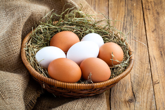 Eggs in basket on wooden background