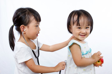 Asian Little Chinese Girls Playing as Doctor and Patient with St