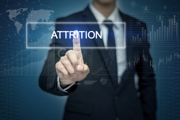 Businessman hand touching ATTRITION  button on virtual screen
