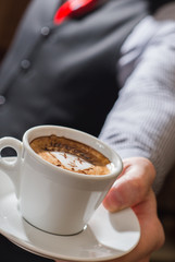 waiter serving coffee cup