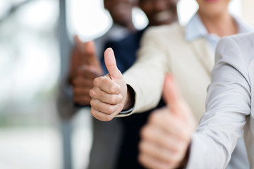 business people giving thumbs up