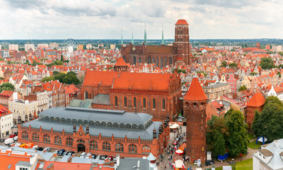 Fototapeta premium Aerial view of the Saint Mary Church, Market Hall and Tower Jacek in the cloudy summer morning, Gdansk, Poland
