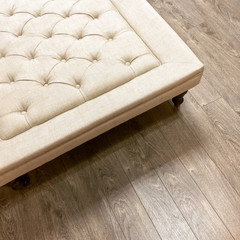 Fancy ottoman on wooden floor