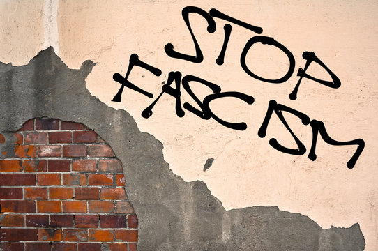 STOP FASCISM text sprayed on the old wall, anarchist aesthetics 