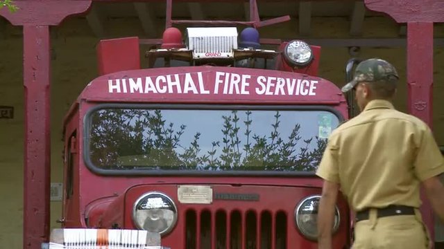 Indian man inspecting fire truck