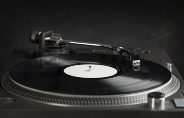 Turntable playing vinyl close up with needle on the record