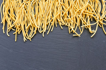 homemade pasta on black background 