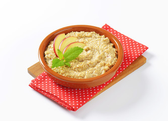 Oatmeal porridge with sliced apple