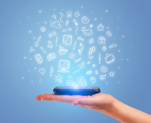 Hand with phone and drawn office icons