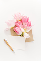  fresh spring pink tulips in envelope on white background