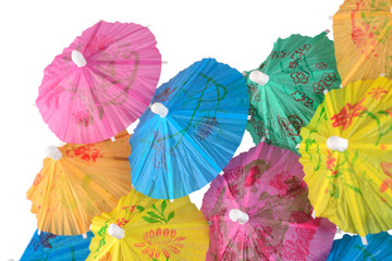 Fototapeta na wymiar Colorful paper cocktail umbrella close-up on a white