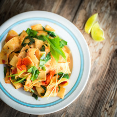 Italian pappardelle with tomatoes and fresh wild garlic leaves.