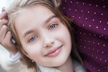 Spring fairy. Portrait of beautiful little smiling girl with brownish blond hair and blue eyes. 