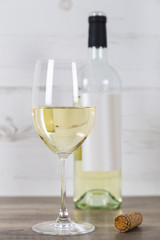 Glass of White Wine and Bottle