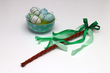 Decorated Easter eggs and a whip of willow twigs (Central Europe Easter symbol), isolated on white background © ditanemcova