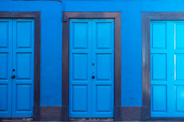 Obraz na płótnie Canvas Background with three blue doors on the blue wall 
