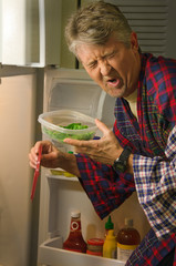 A man hunting for a midnight snack in the refrigerator has found a container with stinking spoiled...