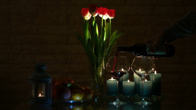 A romantic Candlelit Dinner in a Warm and Cozy Atmosphere with a Glass of red Wine
