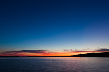 Fototapeta na wymiar Calm sunset and clouds over lake