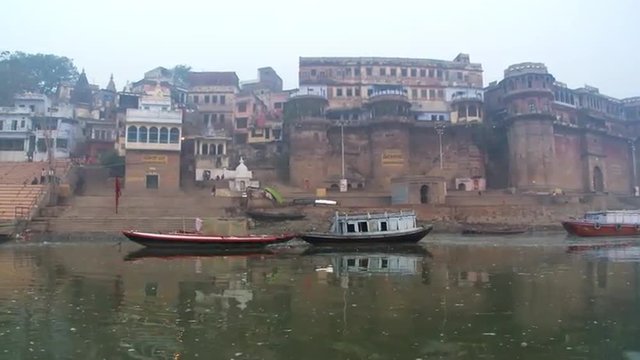 rowing past ancient riverfront of Varanasi