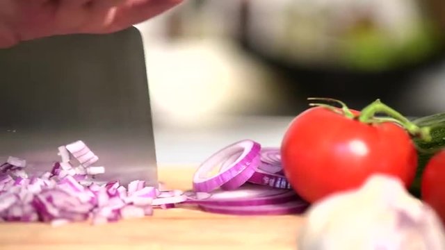 Dicing Red Onions on a wooden chopping board