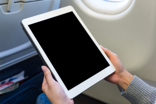 Woman use of the tablet in air plane