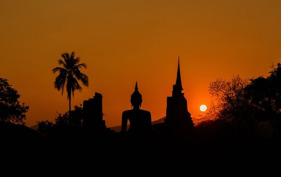 Silhouetteat of Buddha and pagada on sunset time at  Sukhothai H