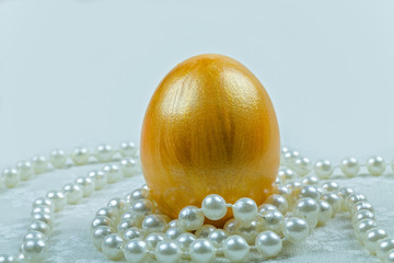 Golden Easter Egg with pearls white background