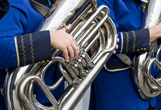 musician plays bass tuba in street orchestra