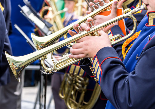 young musicians plays on trumpets at music festival