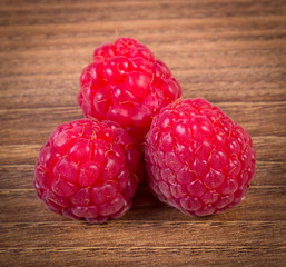 Fresh raspberries on wooden surface, healthy food