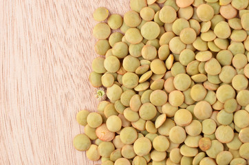 Green lentil on wooden background
