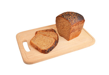 The cut loaf of bread on wooden board